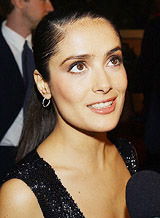 Actress Salma Hayek talks to a reporter as she arrives at the Eighth Annual Critics