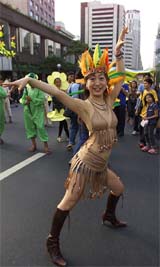 A Japanese tourist in native American attire joins a festival