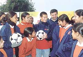 Indian soccer star Baichung Bhutia surrounded by fans