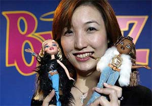 An employee of Japanese toy maker Takaras girls marketing division shows off the US fashion doll, Bratz, during a press preview in Tokyo