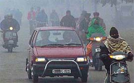 Dense fog forces vehicles to move at a snails pace in Chandigarh on Monday morning