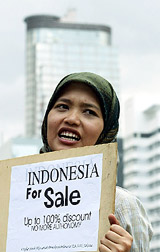A female Indonesian student shouts slogans during a protest