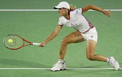 ustine Henin-Hardenne of Belgium hits a low volley