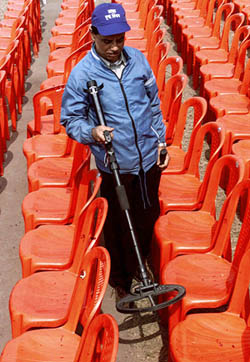 A security official checks for bombs along a parade route in Kolkata on Friday