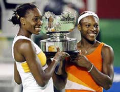Venus Williams of the USA and her sister Serena hold the trophy after defeating Virgina Ruano Pascual of Spain and Paola Suarez of Argentina
