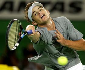 Andy Roddick of the USA fails at a serve by Rainer Schuettler of Germany 