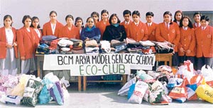 The Principal and in charge of the Eco-Club of BCM Arya Model Senior Secondary School and students with donations for slum-dwellers