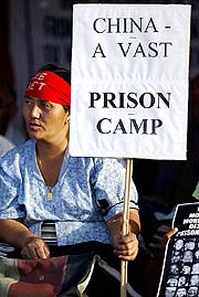 A Tibetan refugee living in India holds a placard condemning the recent execution of a Tibetan