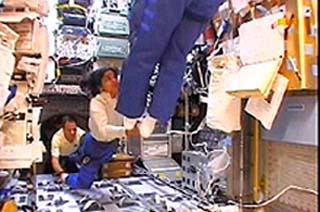 Space shuttle Columbia Commander Rick Husband (foreground), Israeli astronaut Ilan Ramon (L) and astronaut Kalpana Chawla float in the SPACEHAB Double Research Module