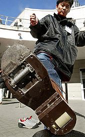 Atsushi Fukunishi, an engineer of Toyota Motor Corp, shows off the sole of a self-propelled shoes