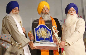 Giani Joginder Singh Vedanti, Jathedar, Akal Takht, and Prof. Kirpal Singh Badungar, president SGPC, present a memento