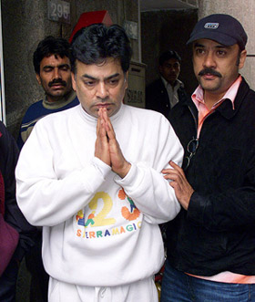 Sanjay Chawla (L), brother of Indian-born astronaut Kalpana Chawla, meets the media outside his home in New Delhi on Sunday