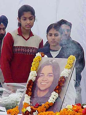 Two students of Tagore Niketan School of Karnal, Kalpana's alma mater, who had visited Kalpana at Houston, USA, stand in front of her picture 