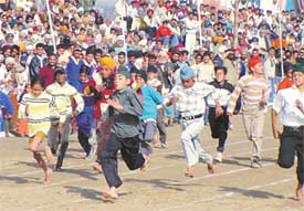 Village children take part in a 100m race