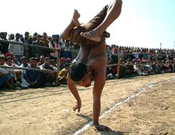 A physically handicapped person showing his skills by walking on his arms 
