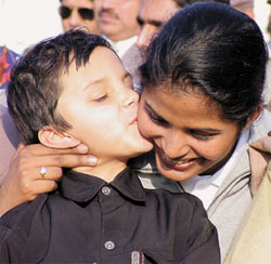 Sunita Rani getting a kiss from her niece after she got back her medals at a function