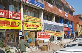 Banners hang in the Sector 35 market of Chandigarh in violation of the Prevention of Defacement of Property Act