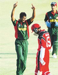 Manjural Islam celebrates after claiming the final wicket of Canadas Austin Codrington