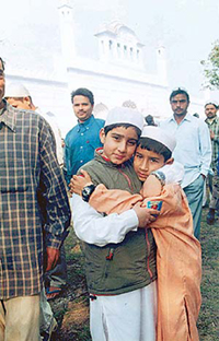 Two boys greet each other on Id in Patiala.