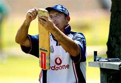 England's Captain Nasser Hussain repairs his bat during a practice session in Cape Town