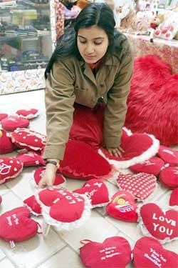 A girl looks at Valentine’s Day hearts at a gift shop