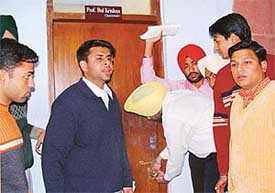 Malwinder Singh Kang, president of the Panjab University Campus Student Council, locks the office of the chairman of the Law Department