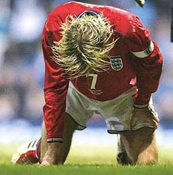 England captain David Beckham recovers from a fall