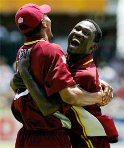 West Indies Mervyn Dillon  is embraced by team-mate Wavell Hinds