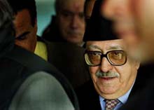 Security guards surround Iraqs Deputy Prime Minister Tareq Aziz 