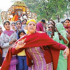 Devotees take part in a nagar kirtan organised in connection with Guru Ravi Dass Jayanti