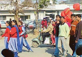 A group of boys chase schoolgirls on Valentines Day