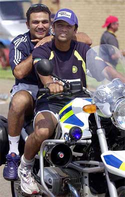 India's Rahul Dravid and Virender Sehwag take a ride on a traffic officer's motorcycle 