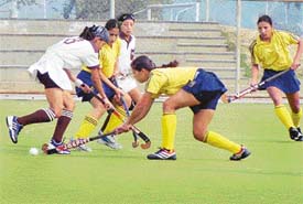 Nishi of Western Railway being checked by Suman Saini of Northern Railway in the final match of Mohinder Pratap Singh Grewal Women Hockey Tournament at PAU