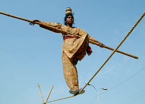 A performer presents a tightrope show on the roadside at Bathinda 