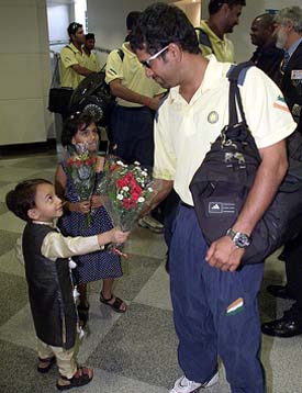 Indian cricketer Sachin Tendulkar is given flowers on his arrival in Harare