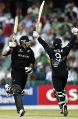 New Zealand captain Stephen Fleming celebrates with teammate Nathan Astle after hitting the winning runs 