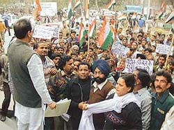 Youth Congress district unit president Parminder Mehta speaks at a protest demonstration against the NDA government