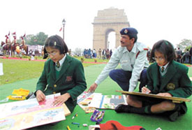 Schoolgirls giving final touches to their paintings