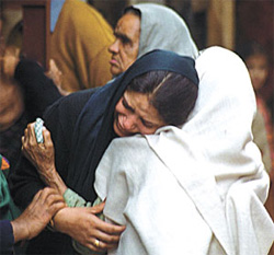 Wailing relatives of 60-year-old Manjit Kaur outside her house at Arjun Nagar