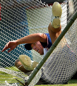 England's wicketkeeper Alec Stewart falls into the nets during a practice session 