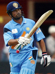 India's Sachin Tendulkar raises his bat after completing his half century 