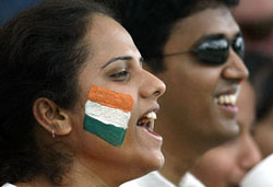 An Indian fan with the national colours painted on her face 