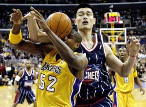 Houston Rockets' Yao Ming of China battles Los Angeles Lakers' Samaki Walker for a rebound 