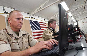 The US military's Central Command personnel sit behind rows of networking computers 