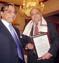 Keshub Mahindra receives AIMA award from N.K. Singh in New Delhi on Friday.