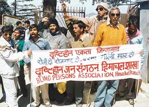 Members of the H.P. Blind Persons Association holding a dharna near the Secretariat in Shimla