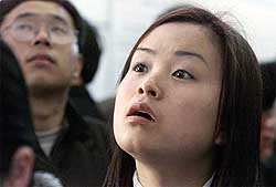 Chinese applicants look at postings on a noticeboard
