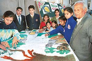 Creator of Rock Garden Nek Chand watches as dexterous hands make patterns during a workshop 