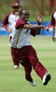 West Indies' Brian Lara throws at the stumps in a practice session 