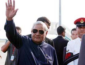 Prime Minister Atal Behari Vajpayee waves to the media on his arrival at Kuala Lumpur international airport 